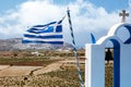 Greece flag and bell tower of the church on greek landscape background. Royalty Free Stock Photo