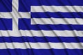 Greece flag is depicted on a sports cloth fabric with many folds. Sport team banner Royalty Free Stock Photo