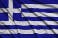 Greece flag is depicted on a sports cloth fabric with many folds. Sport team banner Royalty Free Stock Photo