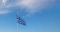Greece flag is flying in air on blue sky background. Banner, place for text Royalty Free Stock Photo