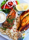 Greece food - Grilled salmon and vegetables on white plate Royalty Free Stock Photo