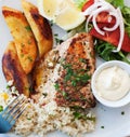 Greece food - Grilled salmon and vegetables on white plate, close up Royalty Free Stock Photo