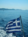Greece flag. Greek flag over the Mediterranean sea. Royalty Free Stock Photo