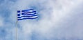 Greece. Greek national official flag on flagpole waving in the wind, blue sky Royalty Free Stock Photo