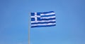 Greece. Greek national official flag on flagpole waving in the wind, blue sky Royalty Free Stock Photo