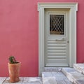 Greece, grey door on colorful fuchsia house wall