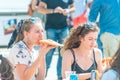 Greece, Heraklion - September 15: Two girls eating street food outdoors. Street food festival