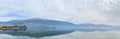 Panoramic view of calming Pamvotida Lake with reflection in Ioannina, Greece Royalty Free Stock Photo