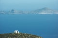 The beautiful Greek island of Anafi.  A lone chapel on top of the cliffs looks out to sea. Royalty Free Stock Photo