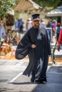GREECE - JULY 17: A greek orthodox priest walking down the street Royalty Free Stock Photo