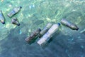 Greece, June, 5, 2020: A group of floating plastic bottles on water surface