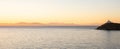 Greece, Kea island. Seascape with lighthouse at sunset