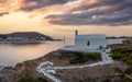 Greece, Kea Tzia island. Small white church on a rocky hill, over Korissia port at sunset Royalty Free Stock Photo