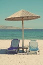 Greece. Kos island. Two chairs and umbrella on the beach. In ins Royalty Free Stock Photo