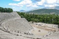 Ancient Greek amphittheater with tourists seen from the top