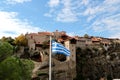 Greece. Meteora. The Greece flag with the Holy Monastery of Great Meteoron, the Transfiguration of Jesus. Royalty Free Stock Photo