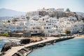 Greece, Naxos harbor, Cyclades islands. View from ship of houses, calm sea, blue sky, sunny day