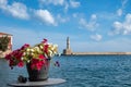 Greece, Old Town of Chania Crete. View of beacon from outdoors cafe. Potted petunia on table Royalty Free Stock Photo