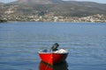 Greece Ã¢â¬â a red row boat moored on placid waters. Royalty Free Stock Photo
