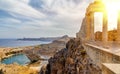 Greece. Rhodes. Acropolis of Lindos. Doric columns of the ancient Temple of Athena Lindia setting sun above the columns Royalty Free Stock Photo