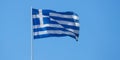 Greece sign symbol. Greek national official flag on flagpole waving in the wind, clear blue sky Royalty Free Stock Photo