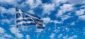 Greece sign symbol. Greek national official flag on flagpole waving in the wind, cloudy blue sky Royalty Free Stock Photo
