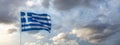 Greece sign symbol. Greek national official flag on flagpole waving in the wind, cloudy sky Royalty Free Stock Photo