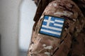 Greece Soldier, Soldier with flag Greece, Greece flag on a military uniform. Camouflage clothing