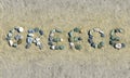 Greece text of colorful pebbles on a beach sand Royalty Free Stock Photo