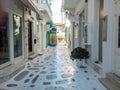 Greece Tinos island, Chora town. Cyclades, souvenir shop, outdoors cafe, paved alley Royalty Free Stock Photo