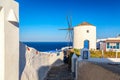 Greece vacation iconic background. Famous windmill in Oia village with traditional white houses during summer sunny day Santorini Royalty Free Stock Photo