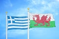 Greece and Wales two flags on flagpoles and blue sky