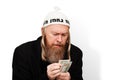 Greedy bearded jewish man counting his money. Thrifty jew with sidelocks in white yarmulke isolated on white background