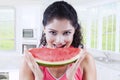Greedy Indian woman eating watermelon