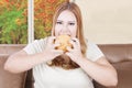 Greedy overweight woman eats burger