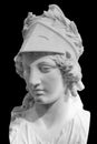 Greek ancient statue of goddess Athena. Woman marble head in helmet sculpture isolated on black Royalty Free Stock Photo