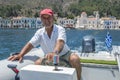 Greek boat captain George heads out of the harbour on the Greek island of Kastellorizo