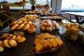 Greek breakfast buffet table full with varieties of pastries, buns, pancakes, donuts, butter cake, pizza, pies, boiled eggs, etc. Royalty Free Stock Photo