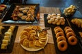 Greek breakfast buffet table full with varieties of pastries, buns, pancakes, donuts, butter cake, local sweets dishes, etc.