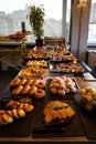 Greek breakfast buffet table full with varieties of pastries, buns, pancakes, donuts, butter cake, pizza, pies, boiled eggs, etc. Royalty Free Stock Photo