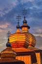 The towers of Greek Catholic wooden church of St. Paraskieva in Dobroslava during epic sunrise