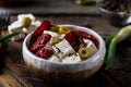 Greek cheese feta with herbs and olives, sundried tomatoes. Bulgarian cheese. Feta in oil. Olove oil. selective focus Royalty Free Stock Photo