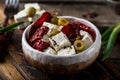 Greek cheese feta with herbs and olives, sundried tomatoes. Bulgarian cheese. Feta in oil. Olove oil. selective focus Royalty Free Stock Photo