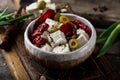 Greek cheese feta with herbs and olives, sundried tomatoes. Bulgarian cheese. Feta in oil. Olove oil. selective focus Royalty Free Stock Photo