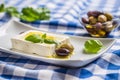 Greek cheese feta with olive oil olives and basil leaves