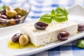 Greek cheese feta with olive oil olives and basil leaves Royalty Free Stock Photo