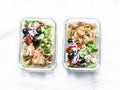 Greek chicken grain lunch box. Lemon herbs chicken, couscous, vegetables, olives, feta cheese lunch box on light background, top
