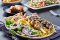 Greek chicken souvlaki platter with pita bread, salad and rice Royalty Free Stock Photo