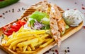 Greek Chicken Souvlaki with salad, french fries potato, pita and tzatziki sauce Royalty Free Stock Photo
