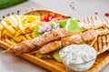 Greek Chicken Souvlaki with salad, french fries potato, pita and tzatziki sauce Royalty Free Stock Photo